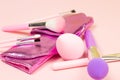 Bright pink decorative cosmetics tools and accessories for professional make up and visage on light background. Royalty Free Stock Photo