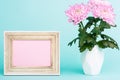 Bright pink flower on a table with empty picture frame greeting card. Happy Mother`s Day, Women`s Day, Valentine`s Day or Birthday Royalty Free Stock Photo