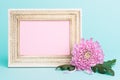 Bright pink flower on a table with empty picture frame greeting card. Happy Mother`s Day, Women`s Day, Valentine`s Day or Birthday Royalty Free Stock Photo