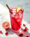 Bright Pink Gin Cocktail with Ruby Grapefruit Slice and Bamboo Straw on White Marble, High Contrast Light Royalty Free Stock Photo