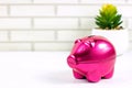 Bright pink pig money box for coins on light wall background with copy space. Economy, budget and savings concept. Royalty Free Stock Photo