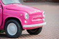 bright pink retro car outside. Spring and summer composition