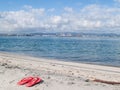 Bright pink sandals left by water\'s edge on Matakana Island Royalty Free Stock Photo