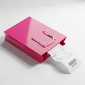 Pink Shopping Bag with a Receipt Partially Pulled Out on a White Surface gift bag retail Royalty Free Stock Photo