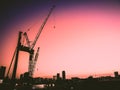 Bright pink sunset. Houses and industrial constructions against beautiful sky  sunset. Cityscape, industrial landscape Royalty Free Stock Photo