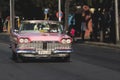 Bright pink vintage vehicle on a country road