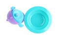 Bright plastic feeding cup and plate isolated, top view. Baby food