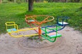 A bright playground surrounded by greenery, many different children's swings, a beautiful and cozy park for Royalty Free Stock Photo