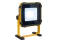 Bright portable led work light on a yellow stand isolated on white background Royalty Free Stock Photo