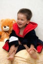 Bright portrait of a cheerful child in terry bathrobe