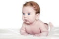 Bright portrait of a cute 3 months baby lying down on a white blanket. Sweet newborn kid. Tummy time