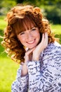 Bright portrait of red-haired young woman outdoors Royalty Free Stock Photo