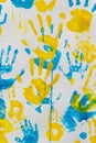 bright prints of children\'s hands from paint on the wall, background, texture Royalty Free Stock Photo