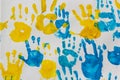 bright prints of children\'s hands from paint on the wall, background, texture, horizontal format Royalty Free Stock Photo