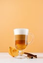 bright pumpkin spice latte in a glass mug with cinnamon Royalty Free Stock Photo