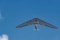 Bright rainbow colored hang glider wing in flight