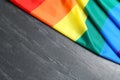 Bright rainbow gay flag on table, top view with space for text. LGBT