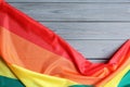 Bright rainbow gay flag on wooden background, with space for text. LGBT community