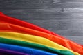 Bright rainbow gay flag on wooden background, space for text. LGBT community Royalty Free Stock Photo