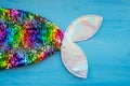 Bright rainbow mermaid tail on a blue background