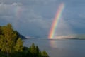 The bright rainbow over the big river. Royalty Free Stock Photo