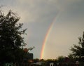 Bright rainbow over the garden. Royalty Free Stock Photo