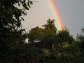 Bright rainbow over the garden. Royalty Free Stock Photo