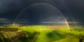 Bright rainbow over green field Royalty Free Stock Photo