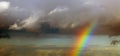 Bright rainbow after the storm in the sunset sky Royalty Free Stock Photo