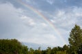 Bright rainbow in the summer over the apple orchard Royalty Free Stock Photo