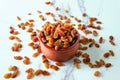 Bright raisins in a ceramic bowl. The concept is raw food, vegetarianism, healthy eating.