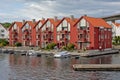 Bright red apartment buildings with Yachts moored in front