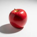 A bright red apple with a glossy surface sits on a white background Royalty Free Stock Photo