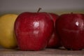 Bright red apples and a yellow one in the back Royalty Free Stock Photo