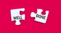 On a bright red background, two white puzzles with the text WELL DONE. View from above Royalty Free Stock Photo