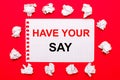 On a bright red background, white crumpled sheets of paper and a sheet of paper with the text HAVE YOUR SAY Royalty Free Stock Photo