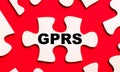 On a bright red background, white puzzles. In one of the pieces of the puzzle, the text GPRS