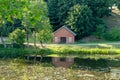 A bright red barn reflected in a pond