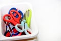 A colorful collection of craft scissors in a white container Royalty Free Stock Photo