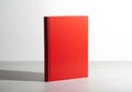 Bright red book on white surface isolated on white background Royalty Free Stock Photo