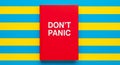 Red book with white text dont panic on blue and yellow Religious Symbol blue background Royalty Free Stock Photo