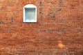 Red brick building wall single white arched window Royalty Free Stock Photo