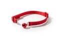 A bright red cat collar with a small silver bell isolated on white background Royalty Free Stock Photo