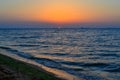 bright red circle of sun yellow pink orange dawn at sea coast, sand shore Royalty Free Stock Photo