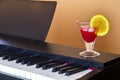 bright red cocktail on the piano