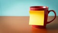 bright red coffee mug with yellow sticky note, symbolizing encouragement and positivity Royalty Free Stock Photo
