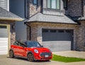 Bright Red Color Car Mini Cooper Parked On Street In a Town Royalty Free Stock Photo