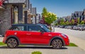 Bright Red Color Car Mini Cooper Parked On Street In a Town Royalty Free Stock Photo