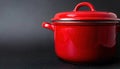 Bright red cooking pot with lid on a dark background showcasing modern kitchenware Royalty Free Stock Photo