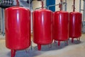 Bright red expansion vessels arranged in a row Royalty Free Stock Photo